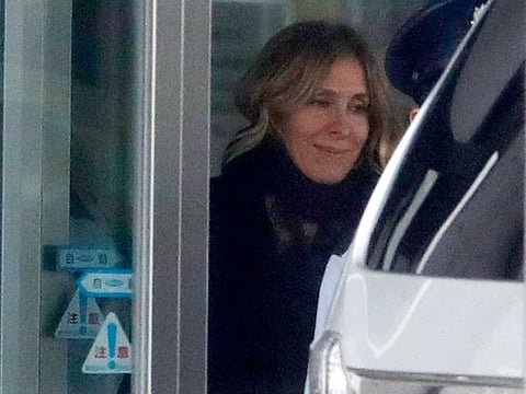 In this March 6, 2019, file photo, Carole Ghosn, wife of Nissan's former Chairman Carlos Ghosn, walks to a car waiting at the entrance of Tokyo Detention Center, where her husband is detained in Tokyo.