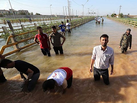 Barricades are set up to contain water in a flooded street in the city of Ahvaz, the capital of Iran's Khuzestan province.