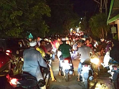 Indonesian residents rushing for higher ground fearing a tsunami after a strong 6.8 magnitude earthquake rocked Luwuk, in Central Sulawesi of eastern Indonesia.