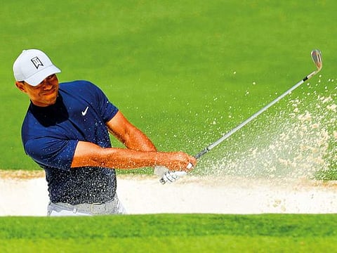 Tiger Woods hits from a bunker of the second hole during the first round for the Masters tournament in Augusta.
