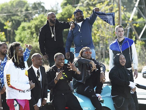 Attendees of a burial service for the late rapper Nipsey Hussle stage to tribute to him before they leave the Forest Lawn Hollywood Hills cemetery, Friday, April 12, 2019 in Los Angeles.
