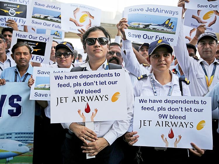 Employees of Jet Airways hold placards