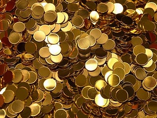 Gold prices inch lower as strong equities weigh