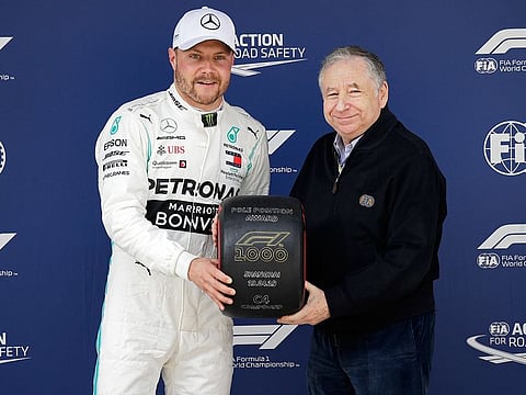 Mercedes driver Valtteri Bottas of Finland, right, left, and FIA president Jean Todt pose for a photograph after taking pole position for the Chinese Formula One Grand Prix at the Shanghai International Circuit in Shanghai, China, Saturday, April 13, 2019. 