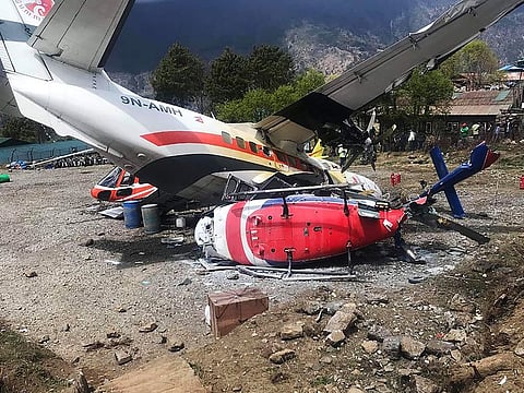 A Summit Air Let L-410 Turbolet aircraft bound for Kathmandu is seen after it hit two helicopters during take off at Lukla airport, the main gateway to the Everest region.  