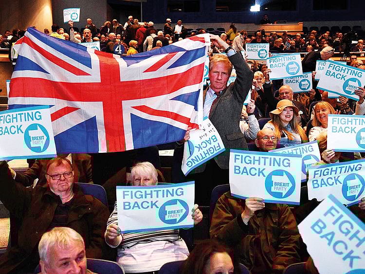 Supporters of The Brexit Party hold placards