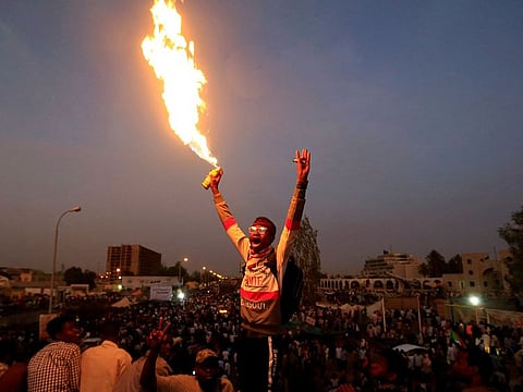 A Sudanese demonstrator chants slogans as he attends a sit-in protest outside the Defence Ministry in Khartoum, Sudan April 14, 2019.