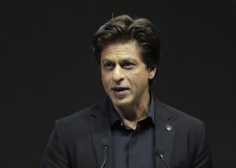 Indian actor Shah Rukh Khan delivers a speech when receiving a Crystal Award during a ceremony on the eve of annual meeting of the World Economic Forum in Davos, Switzerland, Monday, Jan. 22, 2018. The award celebrates the achievements of leading artists who are bridge-builders and role models for all leaders of society. (AP Photo/Markus Schreiber)