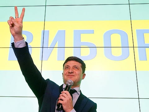 Ukrainian comic actor and presidential candidate Volodymyr Zelenskiy flashes a victory sign following the announcement of the first exit poll in a presidential election at his campaign headquarters in Kiev, Ukraine March 31, 2019.