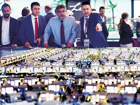 Visitors at the Aldar pavilion during the recently concluded Cityscape Abu Dhabi exhibition. Under the legislative changes, land and residential units in designated investment zones can be registered under Abu Dhabi’s freehold law.