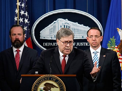 Attorney General William Barr is flanked by Acting Principal Associate Deputy Attorney General Edward O’Callaghan, left, and Deputy Attorney General Rod Rosenstein as he speaks to reporters at the Justice Department about the report by the special counsel, Robert Mueller, on Thursday morning, April 18, 2019.