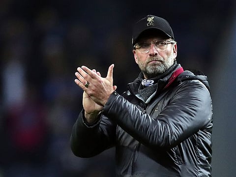 Liverpool manager Juergen Klopp, left, applauds to supporters at the end of the Champions League quarterfinals, 2nd leg, soccer match between FC Porto and Liverpool at the Dragao stadium in Porto, Portugal.