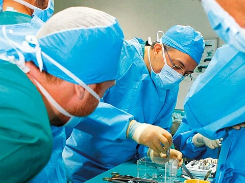 Doctors during the surgery on the 17-year-old girl fitted with a new jaw 3D-printed from bio-compatible titanium 