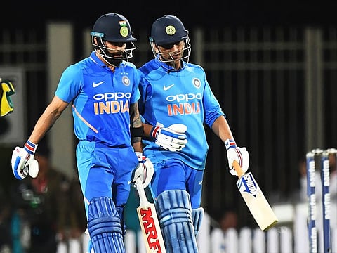In this file photo taken on March 8, 2019, Indian cricket captain Virat Kohli talks with teammate Mahendra Singh Dhoni (R) during the third one-day international (ODI) cricket match between India and Australia at the Jharkhand State Cricket Association International Cricket Stadium, in Ranchi. 