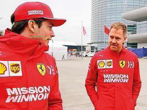Ferrari’s Sebastian Vettel (right) chats with his teammate Charles Leclerc at the Shanghai International Circuit last week.