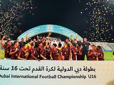 Flamengo players celebrate with the trophy after winning the ninth Dubai International Under-16 football championship for the second time in a row on Friday.