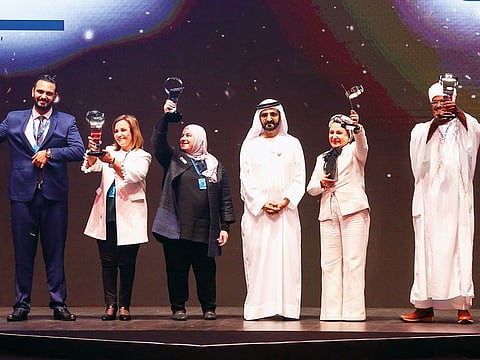 File photo: Shaikh Mohammad Bin Rashid with Mahmoud Wahid, winner of the Arab Hope Makers award, and other finalists during a ceremony in Dubai on May 14, 2018.