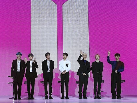 Members of South Korean K-Pop group BTS wave during a press conference to introduce their new album "Map of the Soul: Persona" in Seoul, South Korea, Wednesday, April 17, 2019.