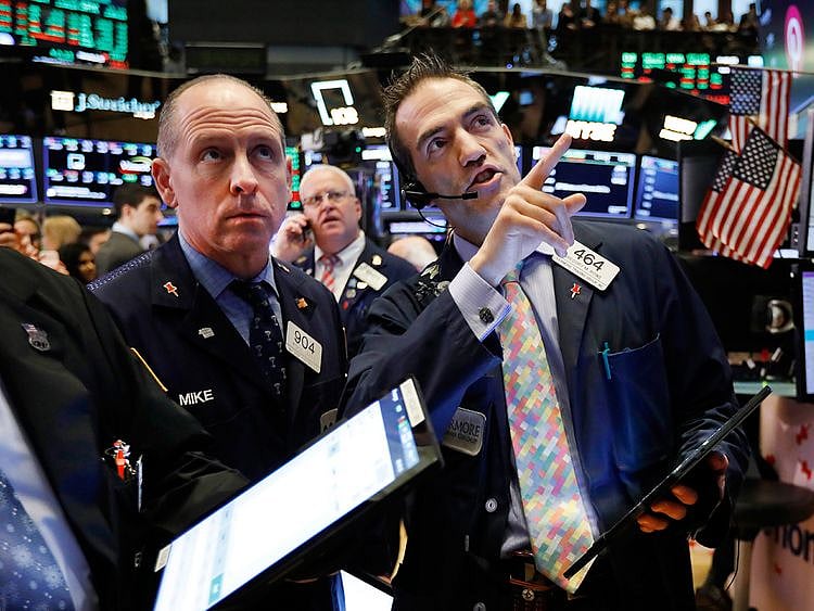 Traders work on the floor of the New York Stock Exchange