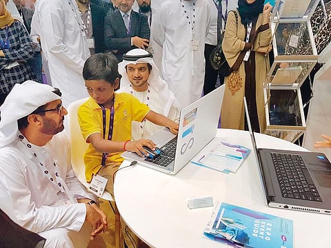 Hussain Ebrahim Al Hammadi (left) discusses the latest educational tools with a student at the BETT MEA conference and expo at the Abu Dhabi National Exhibition Centre on Monday.