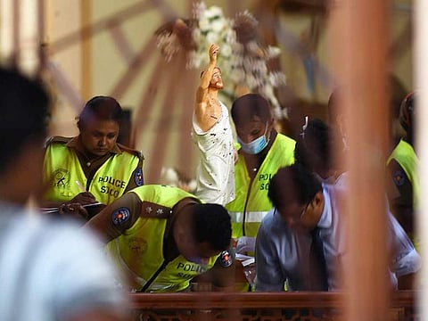 Security personnel inspect inside St. Sebastian's Church in Negombo on April 22, 2019, a day after the church was hit in series of bomb blasts targeting churches and luxury hotels in Sri Lanka. 