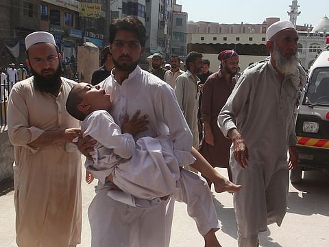Family member rush a boy to a hospital after receiving a polio vaccination, in Peshawar, Pakistan, Monday, April 22, 2019.