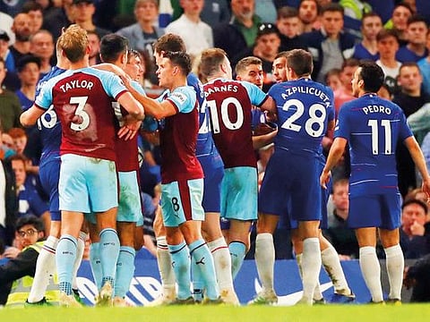 Chelsea and Burnley players clash after the Premier League match at Stamford Bridge on Monday. Clashes erupted after the tie ended in a 2-2 draw.