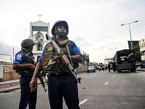 Sri Lankan soldiers stand guard near a car explosion after the police tried to defuse a bomb near St. Anthony's Shrine in Colombo on April 22, 2019, a day after the series of bomb blasts targeting churches and luxury hotels in Sri Lanka