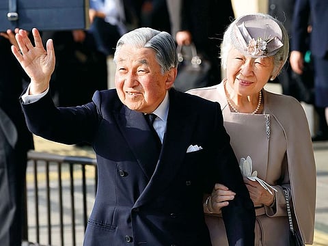 Japan's Emperor Akihito and Empress Michiko wave to well-wishers before leaving Ujiyamada Station after their visiting Ise Jingu shrine in Ise in the central Japanese prefecture of Mie on April 18