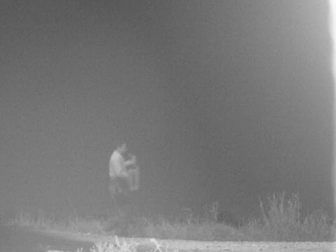 In an undated image provided by the CBP, a Customs and Border Protection agent carries a three-year-old child found alone in a cornfield near Fort Brown, Texas.