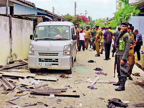 Sri Lankan police and army soldiers secure the site after an explosion and a gunbattle in Kalmunai, in eastern Sri Lanka Saturday, April 27, 2019. 