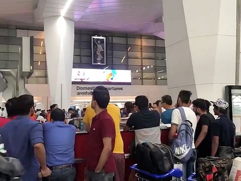 Air India flight passengers stranded at the Indira Gandhi International Airport, in New Delhi. 