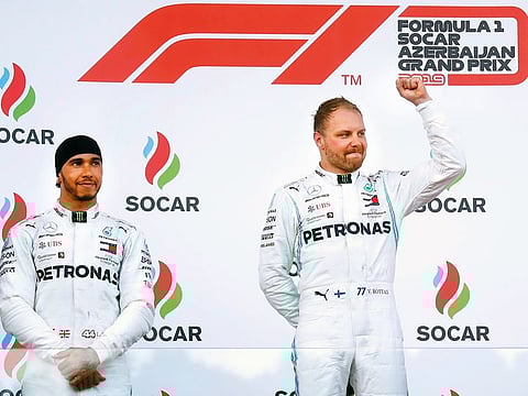 Mercedes’ Valtteri Bottas celebrates winning the race on the podium as second placed Lewis Hamilton looks on during the Azerbaijan Grand Prix at Baku City Circuit on Sunday.