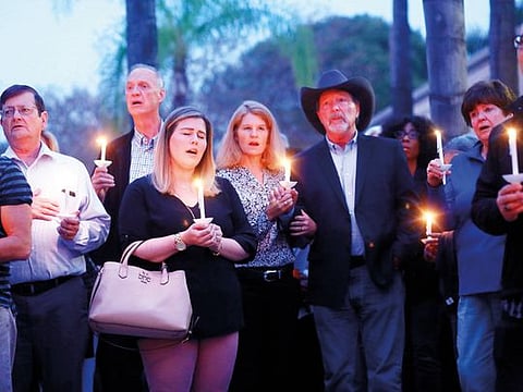 Mourners, including Poway Mayor Steve Vaus (hat) and his wife Corrie, participate in a candle light vigil for the victims of the Chabad of Poway Synagogue shooting at the Rancho Bernardo Community Presbyterian Church on April 27, 2019 in Poway, California. 