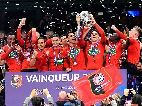 Rennes' players celebrate with the trophy after winning the French Cup final football match between Rennes (SRFC) and Paris Saint-Germain (PSG), on April 27, 2019 at the Stade de France in Saint-Denis, outside Paris.  