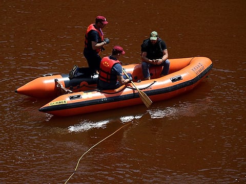 Members of the Cyprus Special Disaster Response Unit search for a suitcase in a man-made lake, near the village of Mitsero outside of the capital Nicosia, Cyprus, Monday April 29, 2019. 