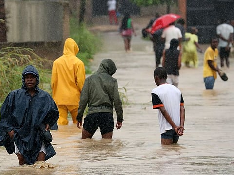 Residents wade through a flooded road in the aftermath of Cyclone Kenneth in Pemba, Mozambique, April 28, 2019. Picture taken April 28, 2019.