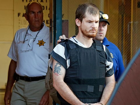 Smith County Sheriff Charlie Crumpton, left, watches as Timothy Ray Jones Jr., is escorted by lawmen out of the Smith County Jail to a vehicle for transport to Lexington County, S.C. in Raleigh