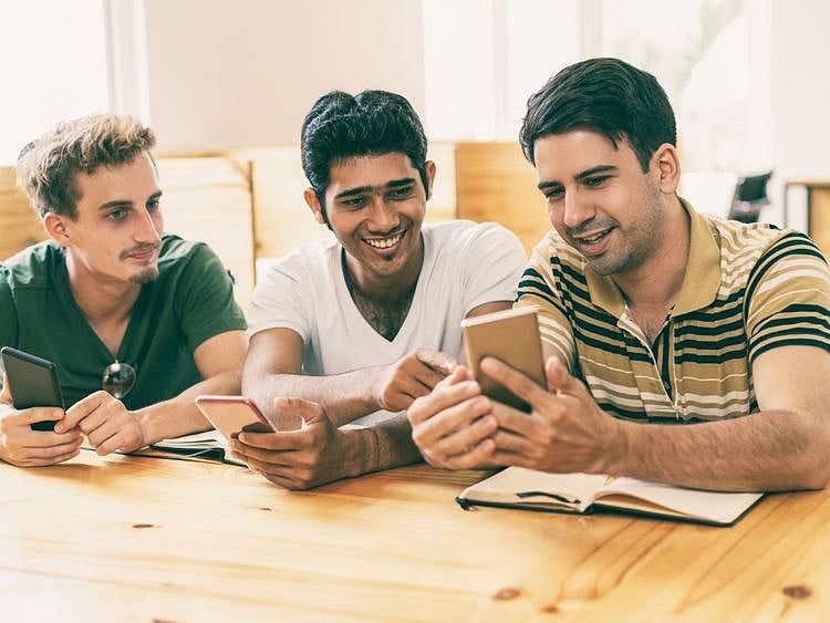 tab__Indians_looking_at_mobiles_in_a_group-1556541373389