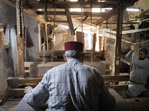 Abdelkader Ouazzani, the last of Morocco's brocade master weavers, works at his workshop in the old city of Fes