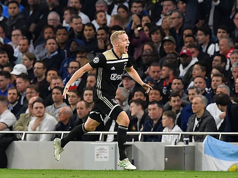 Ajax's Dutch midfielder Donny van de Beek celebrates scoring.