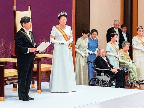 Japan's Emperor Naruhito (L), watched by Empress Masako (C), giving a speech during a ceremony to receive the first audience after the accession to the throne at the Matsu-no-Ma state room inside the Imperial Palace in Tokyo. 
