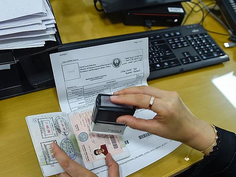 An employee at work at the General Directorate of Residency and Foreign Affairs (GDRFA) in Dubai.  