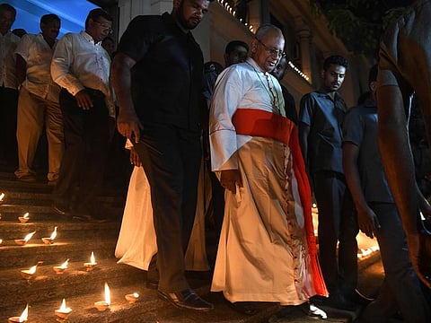 Archbishop of Colombo, Cardinal Malcolm Ranjith (C) attends a candle light vigil in memory of the victims in Colombo on April 28, 2019, a week after a series of bomb blasts targeting churches and luxury hotels on Easter Sunday in Sri Lanka.