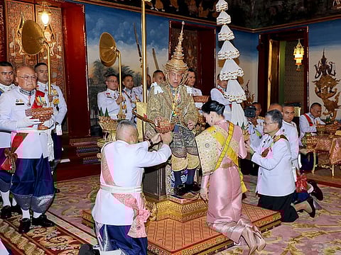 Thailand's King Maha Vajiralongkorn sits on the throne and perform rituals as Queen Suthida pay homage as he is officially crowned king at the Grand Palace, in Bangkok. 