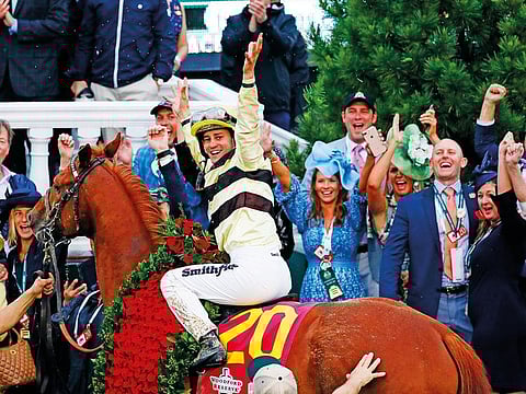 Flavien Prat celebrates after riding Country House to victory during the 145th running of the Kentucky Derby on Saturday.
