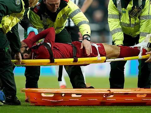 Liverpool's Mohammad Salah receives treatment after an injury during a Premier League match against Newcastle United at St James' Park, Newcastle, England, Saturday May 4, 2019.