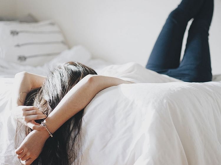 girl relaxing on her bed