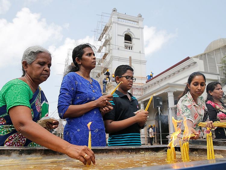 Sri Lankan Catholic devotees light candles