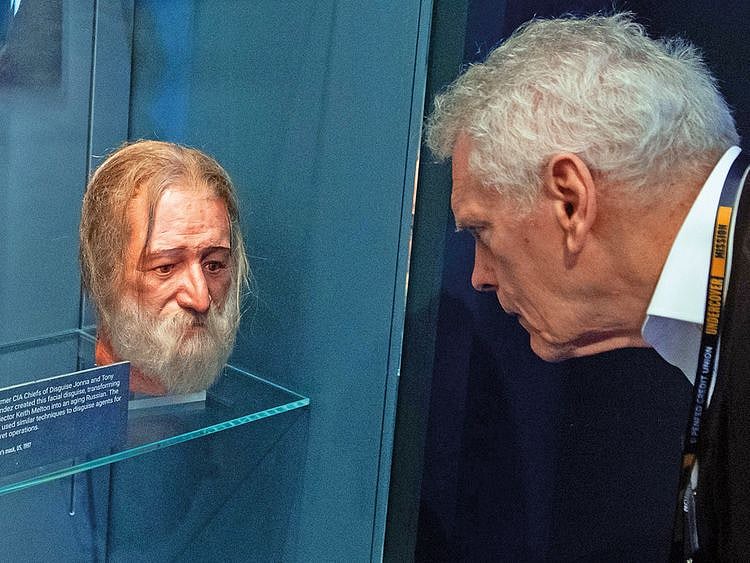 A man looks at an example of a facial disguise